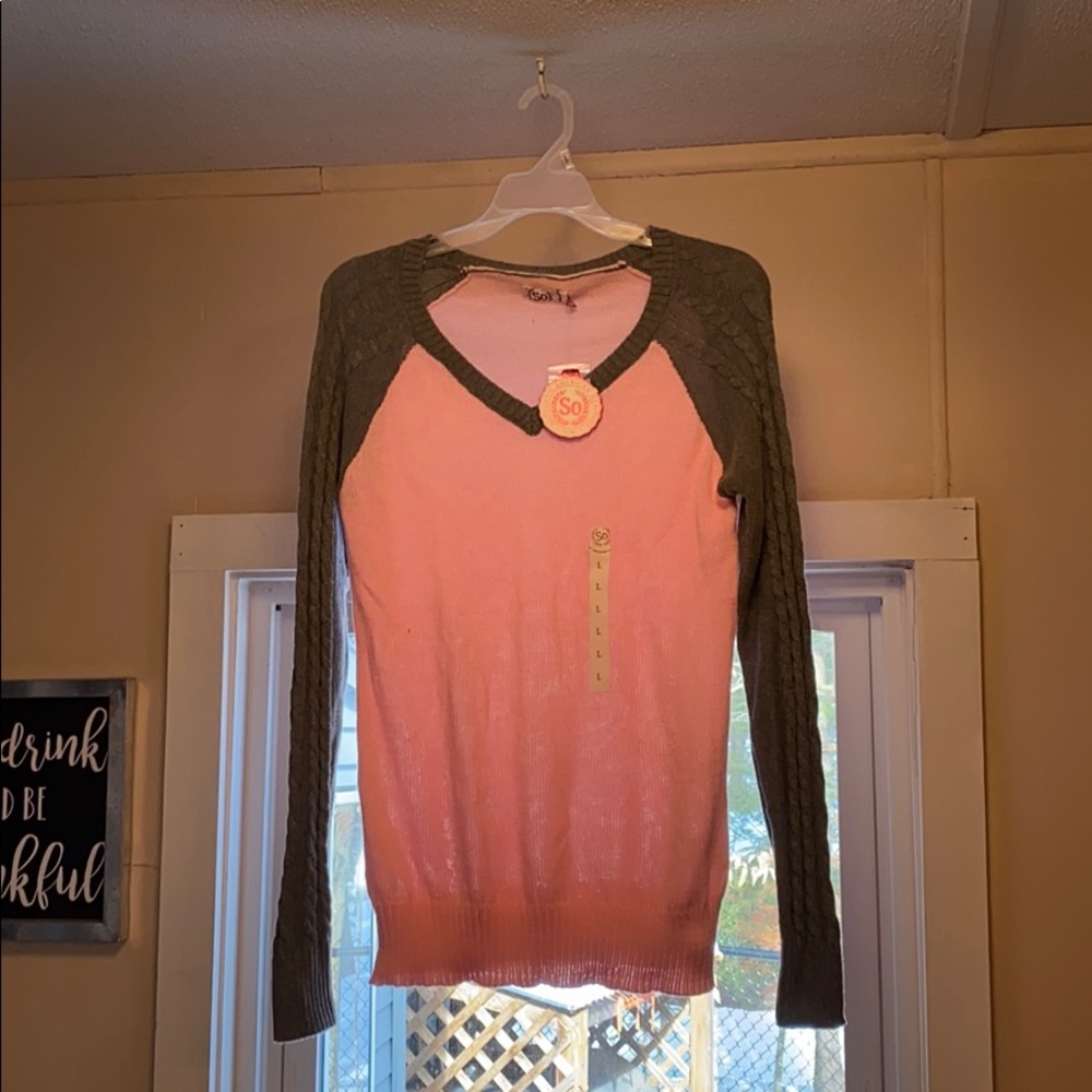 Pink and grey sweater.
